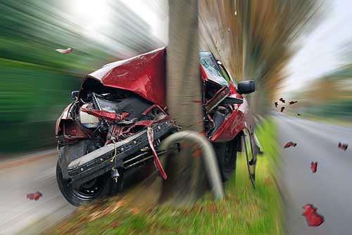 A red car that has struck a tree.