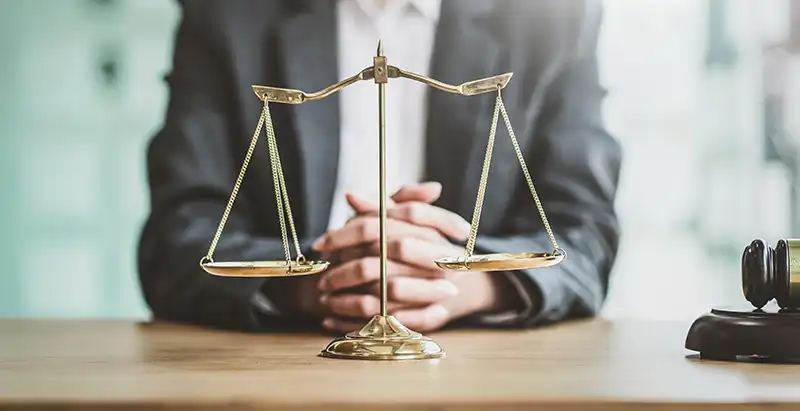 personal injury lawyer sitting with a scale