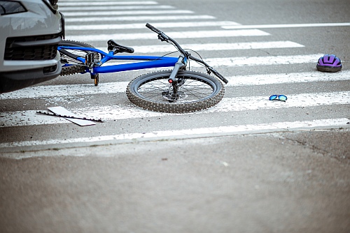 bike accident with car and broken bicycle